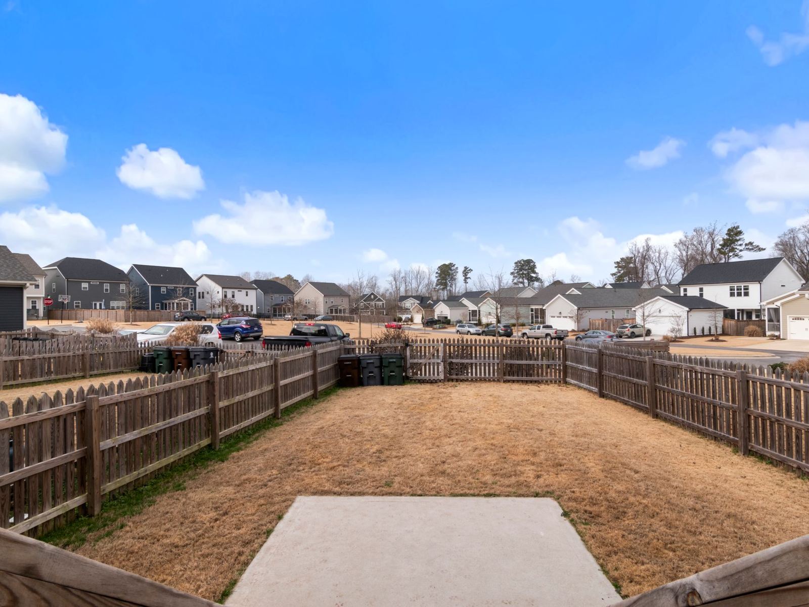 Wooden privacy fence enclosing a new suburban backyard